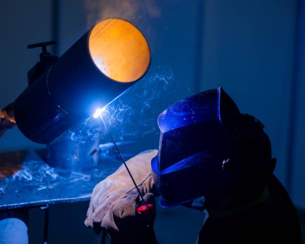 istock A man wearing a protective mask welds a metal pipe. 2198771074
