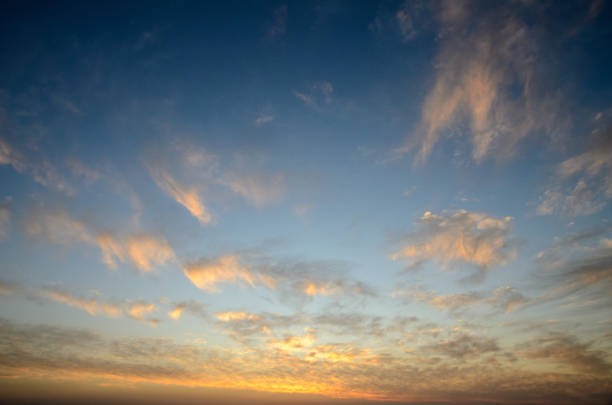 istock Colorful clouds dance across the evening sky as the sun sets on a tranquil horizon 2198771932