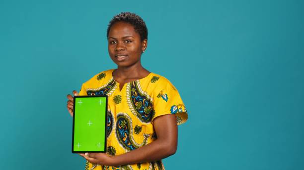 istock Happy natural girl showing a green screen against blue background 2198772464