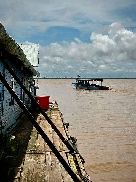 istock Boat Leaving Floating Village (Tonle Sap, Cambodia) 2198773271