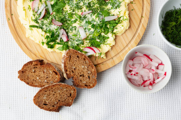 Nettle butter - homemade bread spread made of wild edible plants, on a slice of sourdough bread, close up