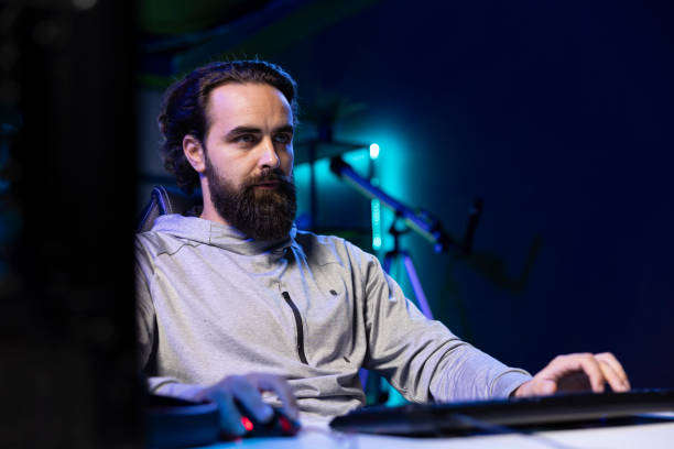 istock Man talking with audience during livestream, presenting helpful videogame 2198774539