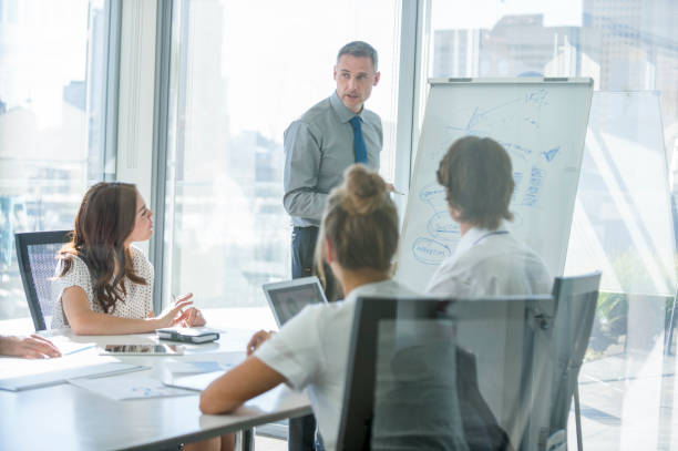 istock Businessman giving a presentation to his team. 2198778039