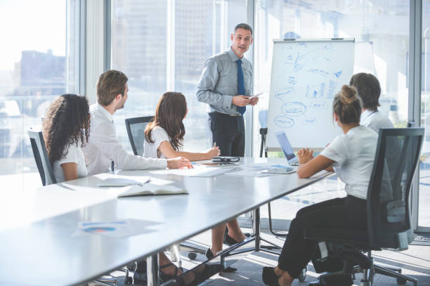 istock Businessman giving a presentation to his team. 2198778082
