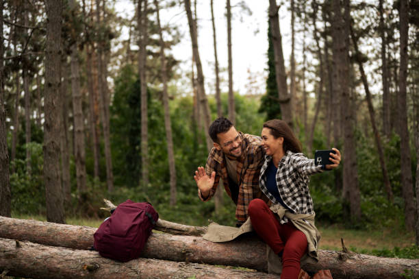 istock Young female talking on the smart phone and resting from hiking 2198778388