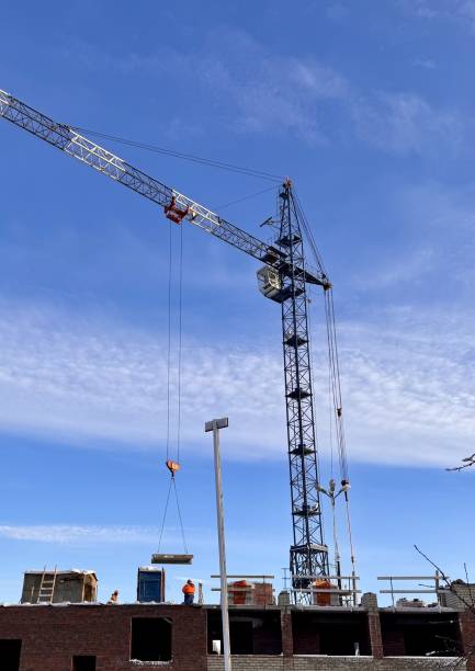 istock Construction crane and vehicles outdoors on the background buildings in winter 2198778672