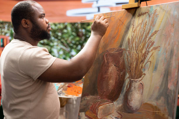 istock Painter applies watercolor paints on a canvas with a certain technique 2198781052