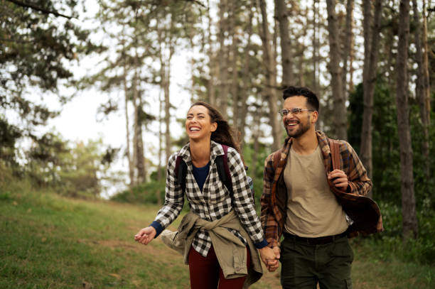 istock Young couple walking through the forrest and exploring nature 2198783367