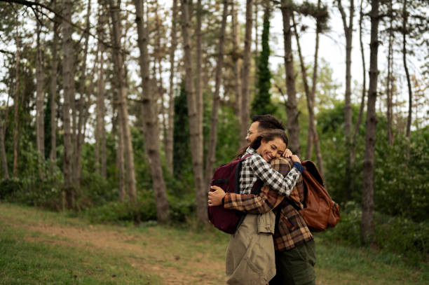 istock Young couple walking through the forrest and exploring nature 2198783464