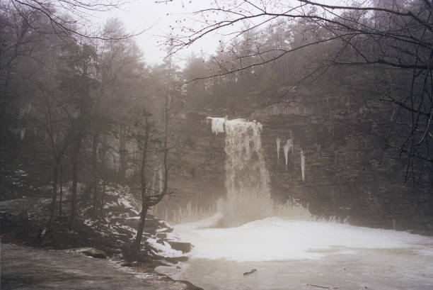 Image in film of a waterfall in winter time in New York State during a foggy day