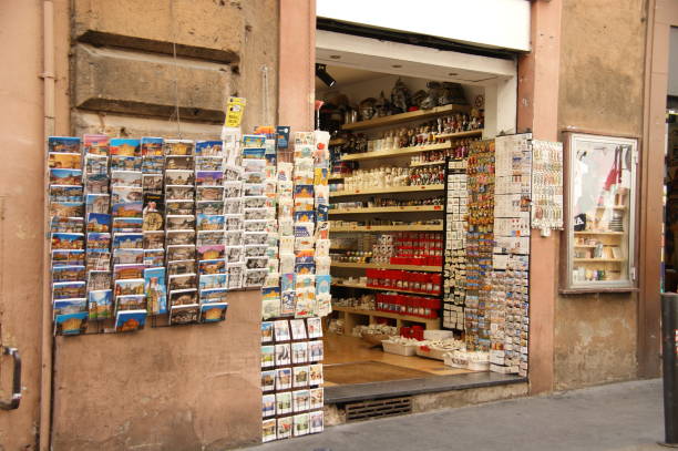 A colouful store brimming of souvenirs and postcards at Siena, Italy. The photo shows the facade of the shop with weathered and old walls.
