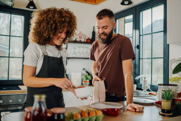 istock Happy couple preparing breakfast in modern kitchen 2198785711