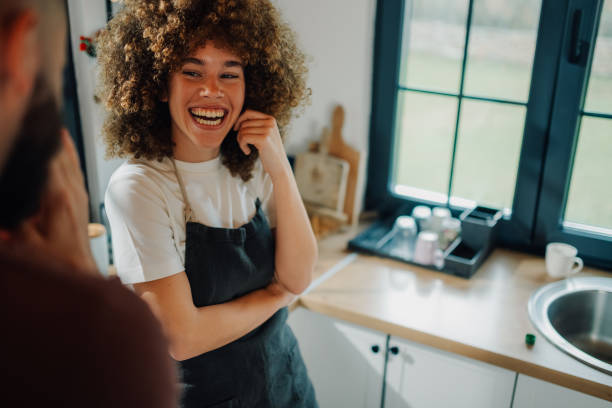 istock Smiling waitress wearing apron talking with customer in restaurant kitchen 2198785720