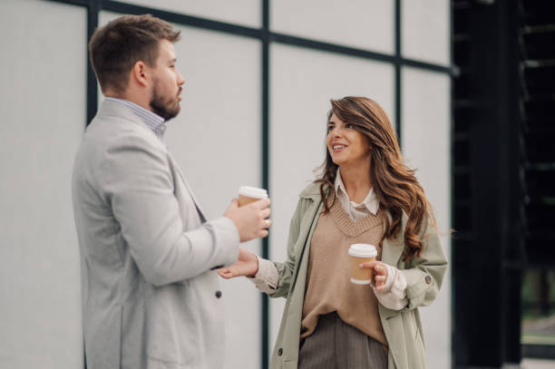 istock Business people talking and holding disposable coffee cups 2198786160