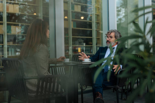 istock Business partners discussing during a coffee break at a cafe 2198786819