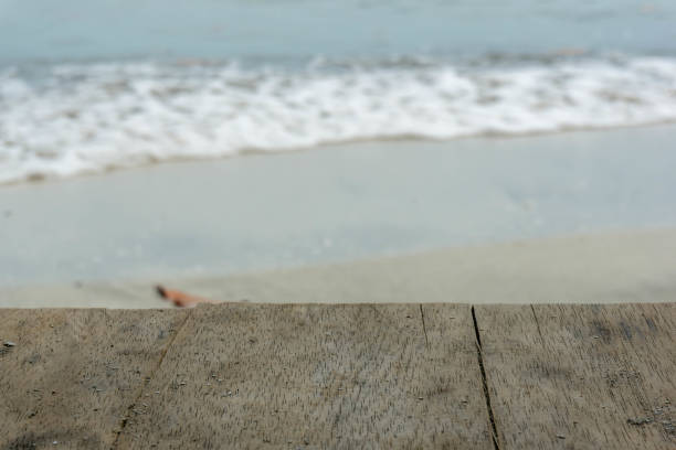 istock table top with blurred background of foam waves on the beach 2198788989