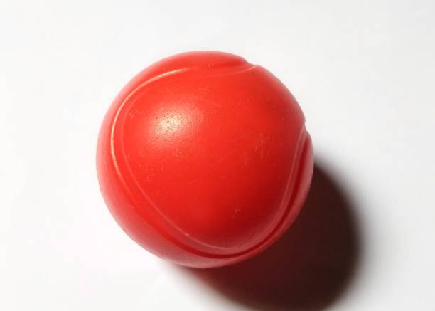 istock Red Smooth Ball on a White Background With Shadows 2198789534