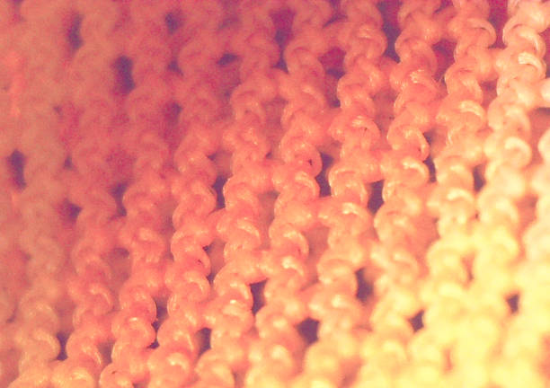 Small knitting, needlework. A fragment of fabric, textiles in detail. Image under the microscope, micro photography. Science, study and education. Multiple zoom, close-up. Scientific photography new