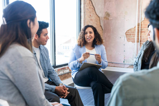 istock Group therapy session with a diverse group of adults 2198798477