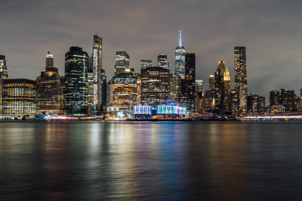 istock New york city skyline reflecting over water at night 2198798628