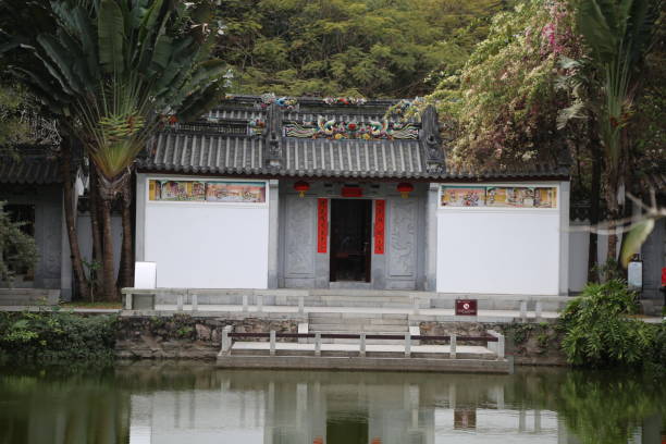 In the park, there is an ancient Chinese-style white building with red decorations on its walls and roof