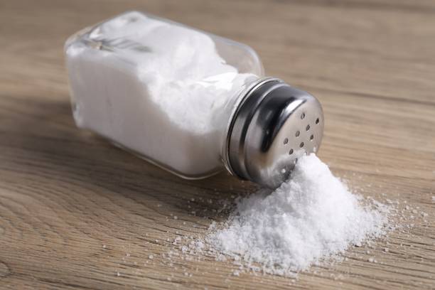 istock Natural salt in shaker on wooden table, closeup 2198802831