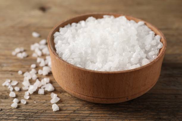 istock Natural salt and bowl on wooden table, closeup 2198802916