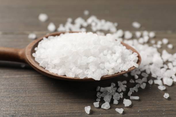 istock Natural salt with spoon on wooden table, closeup 2198802923
