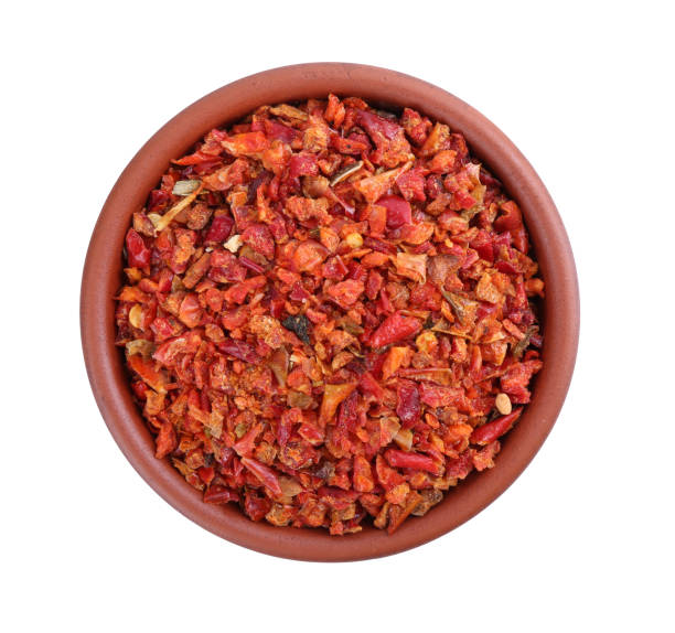 istock Aromatic spice. Red chili pepper flakes in bowl isolated on white, top view 2198803057
