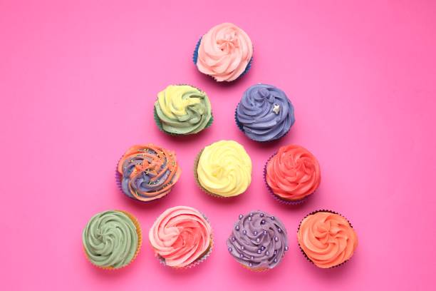 istock Delicious cupcake with bright cream on pink background, flat lay 2198805319