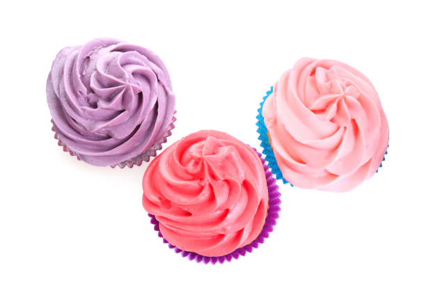 istock Different tasty cupcakes with cream isolated on white, top view 2198805490