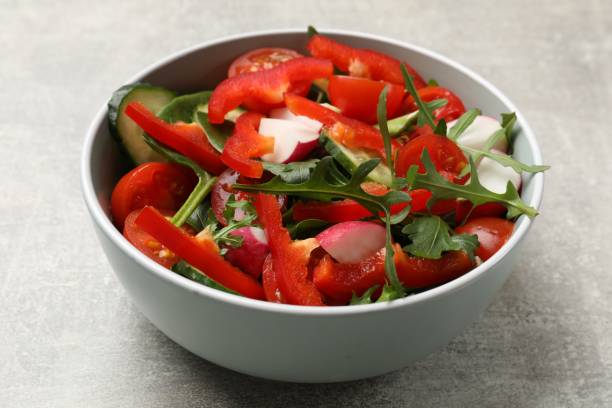 istock Tasty fresh vegetarian salad on light grey table, closeup 2198806465
