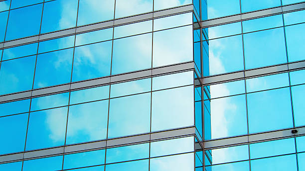 istock The reflective glass panels seamlessly mirror the blue sky, enhancing the structure's modern aesthetic. 2198806662