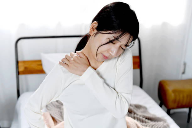 istock Asian young woman suffering from stiff shoulders 2198807627