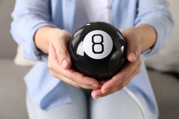istock Woman holding magic eight ball indoors, closeup 2198807748