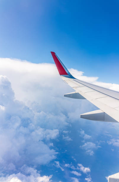 istock View from the airplane window at a beautiful cloudy sky and the airplane wing 2198809107