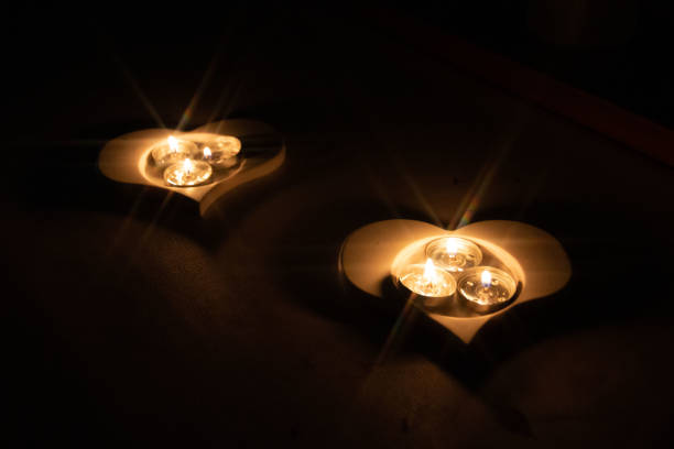 romantic heart-shaped candlesticks with tea candles taken in the dark