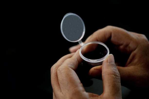 istock Hand Holding Wine in a Holy Communion. Darkness background 2198810413