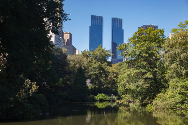 Pond lake in Central Park and Time Warner center skyscraper towers, Midtown Manhattan, New York City The Pond lake in Central Park and Time Warner center skyscraper towers, Midtown Manhattan, New York City time warner center columbus circle pictures stock pictures, royalty-free photos & images