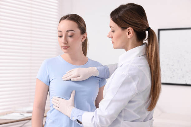 istock Mammologist checking young woman's breast in hospital 2198812472