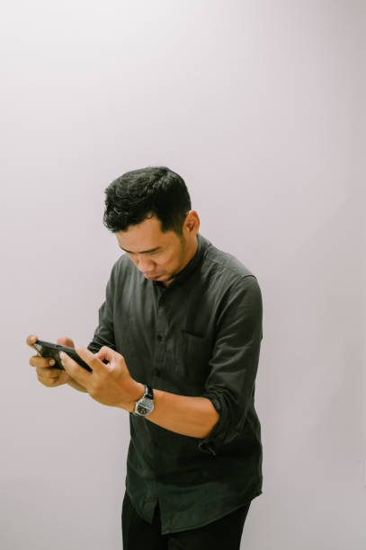 istock Young Man Gaming on Smartphone so cool 2198814405