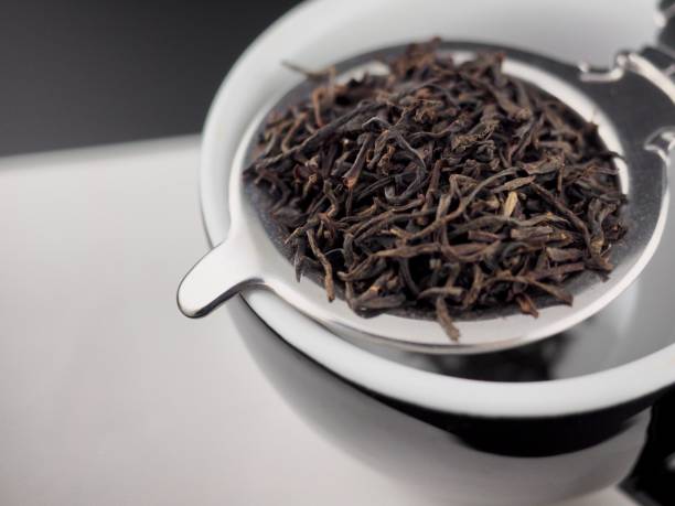 istock Dried black tea leaves, closeup 2198815884