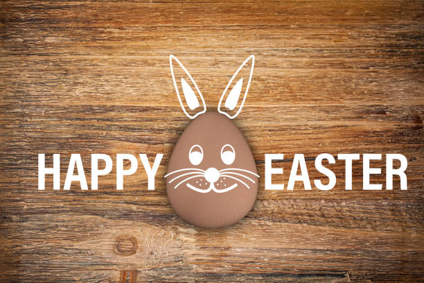 3d render of brown egg with Easter bunny face and the text Happy Easter on rustic wood - background - happy Easter