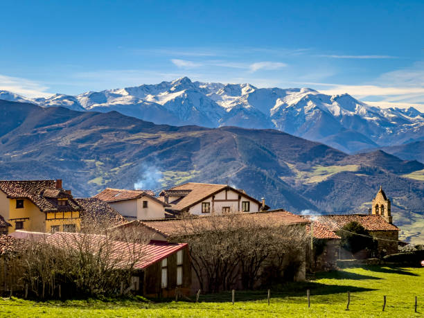 istock Charming village with snow-capped mountain backdrop 2198827076