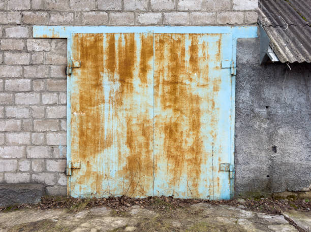 istock A rusted blue door with a brick wall behind it 2198828073