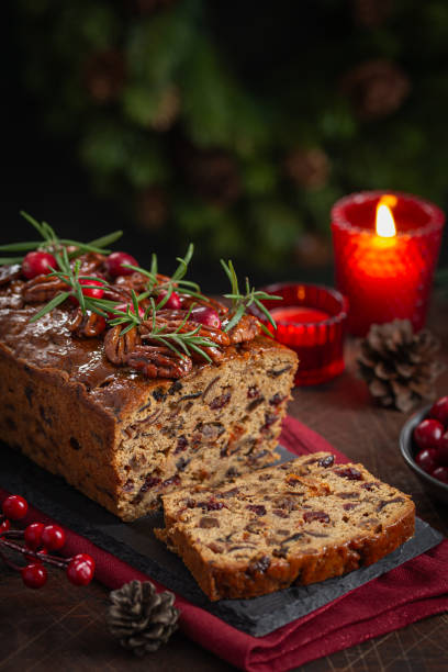 Traditional homemade Christmas loaf fruit cake for holiday dinner, wooden background