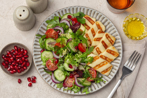 istock close up of fried halloumi cheese with fresh vegetable salad 2198830107