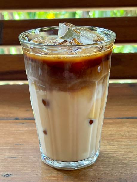 istock Iced coffee in a glass on wooden table with blur background 2198832399