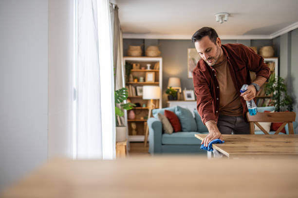 istock Man cleaning up at home, keeping his space neat 2198833958