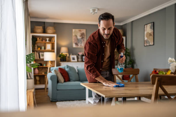 istock Man cleaning up at home, keeping his space neat 2198833981